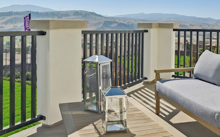 A deck with a chair and a table on it.