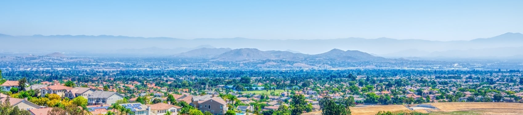 A city with mountains in the background.