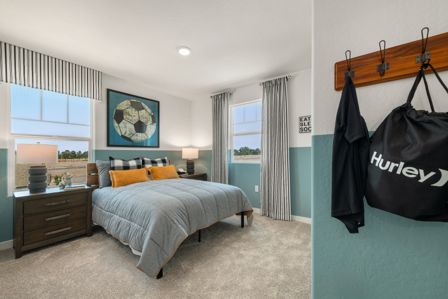 A bedroom with a bed and a desk.