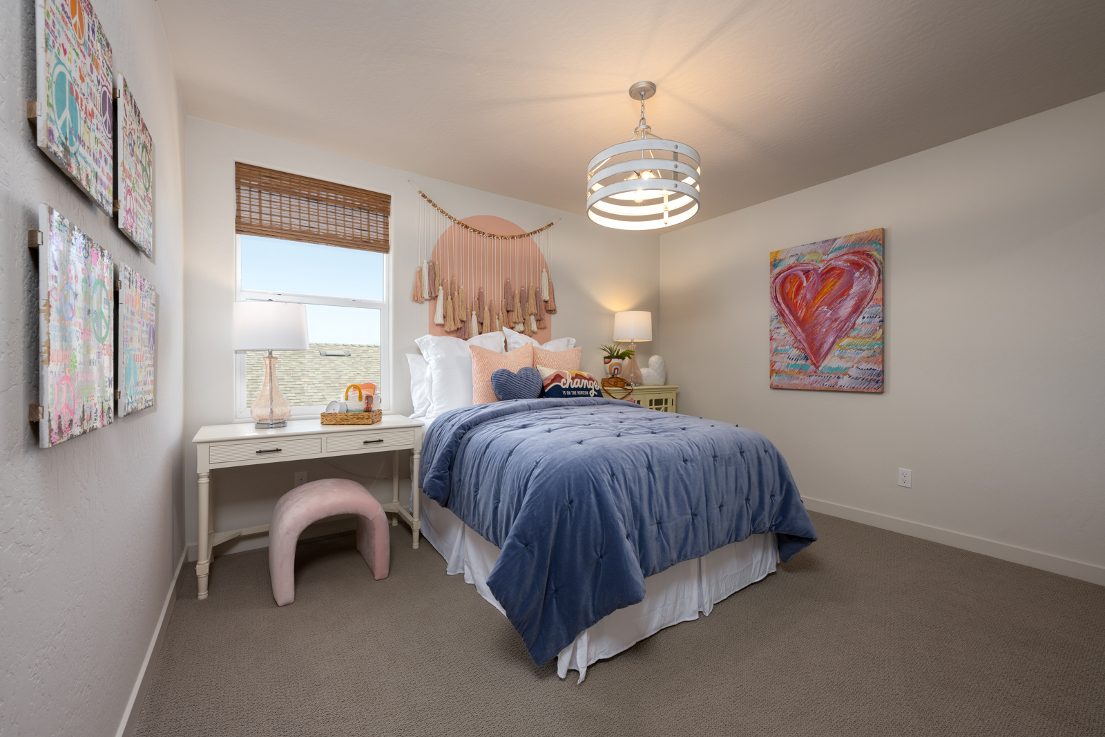 A bedroom with a bed and desk.