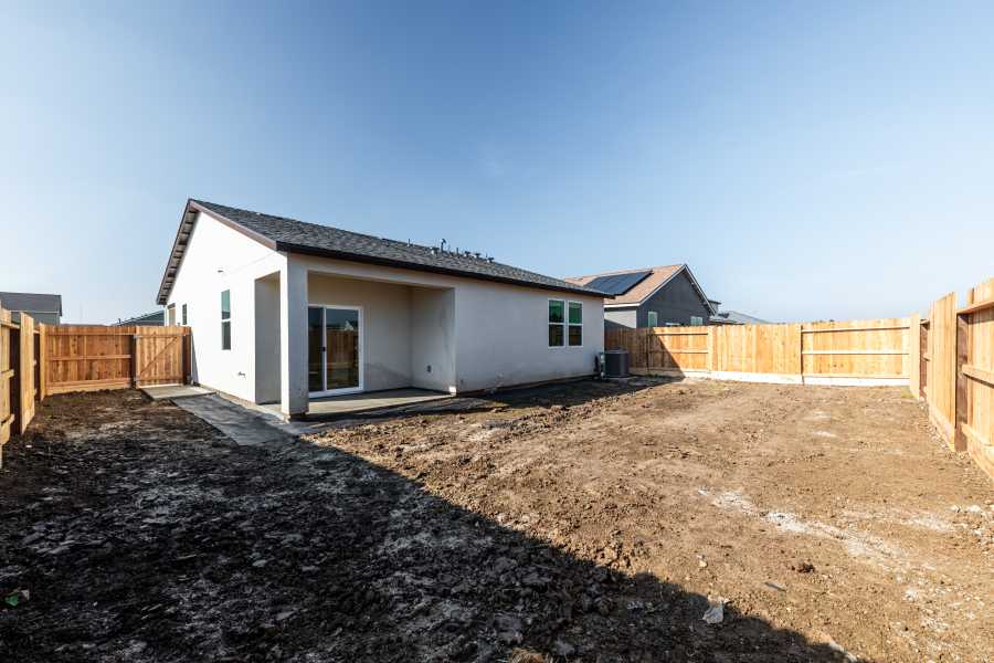 A house with a dirt yard.