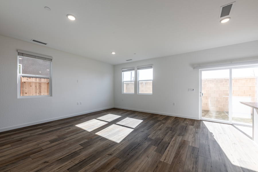 A room with windows and wood floor.