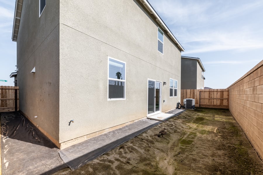 A white building with a fence.