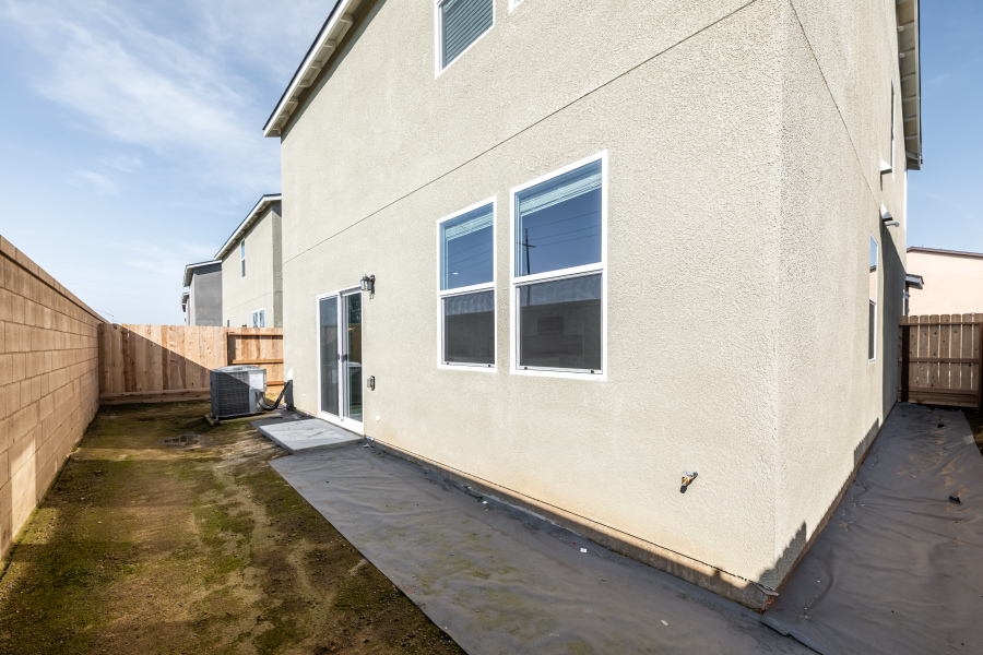 A white building with a fence.