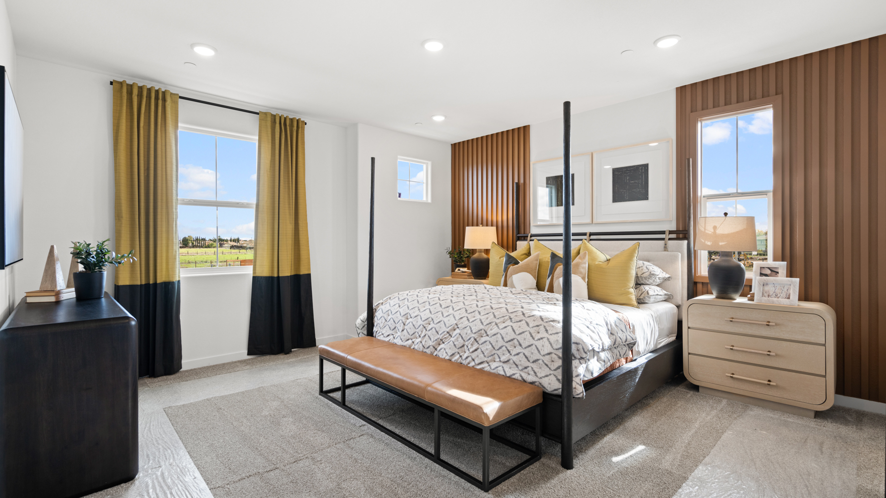 A bedroom with a bed and a bench.