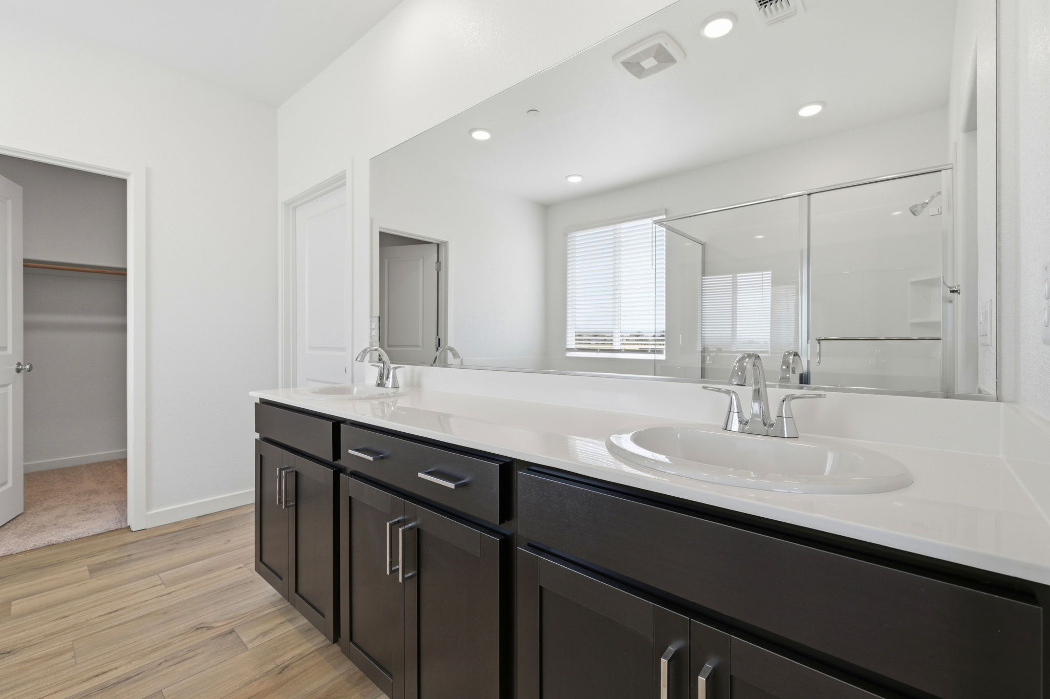 A bathroom with a large mirror.