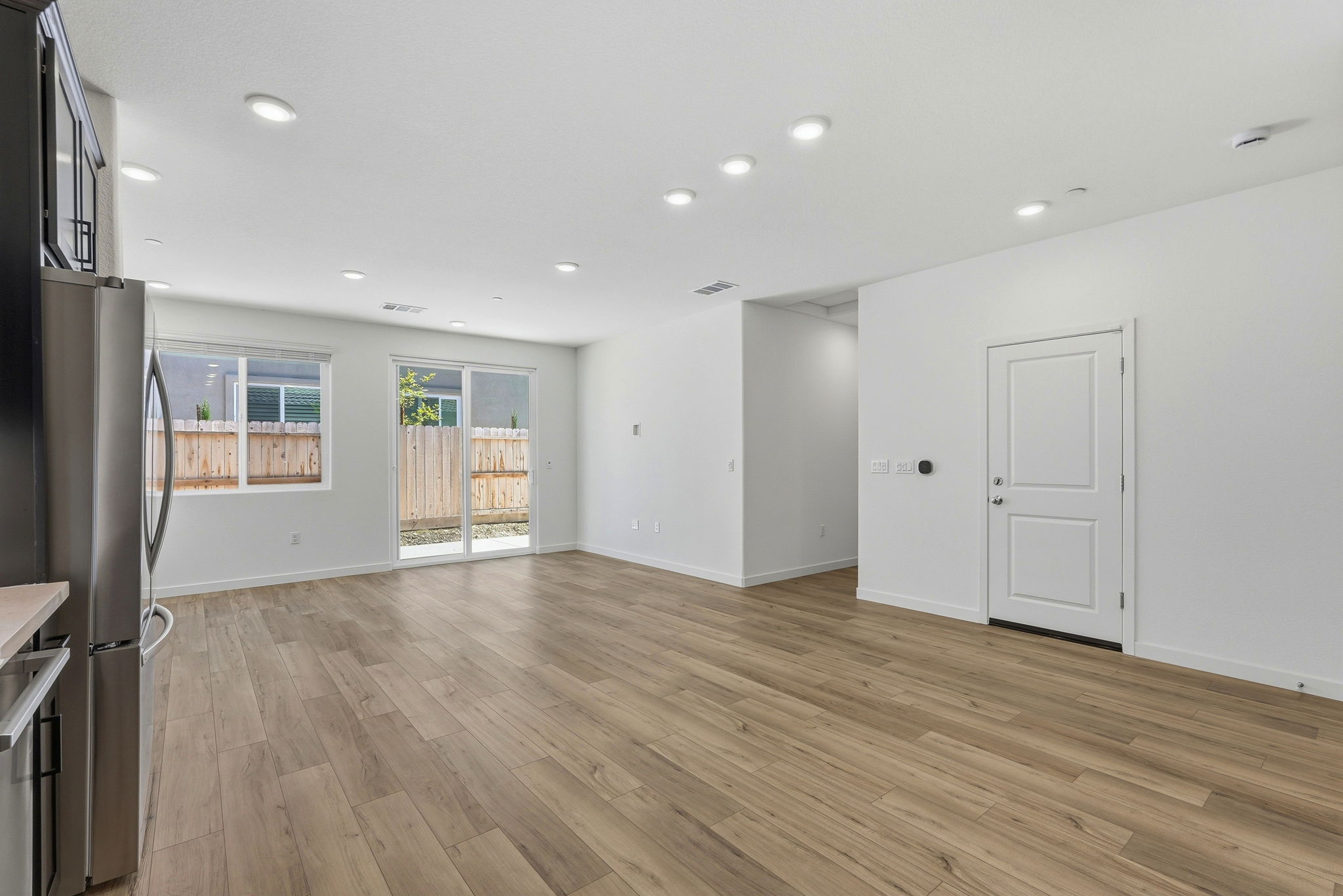 A room with white walls and wood floors.