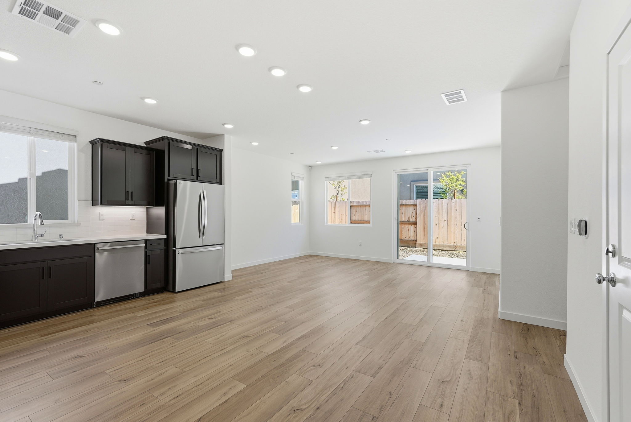 A large kitchen with wood floors.