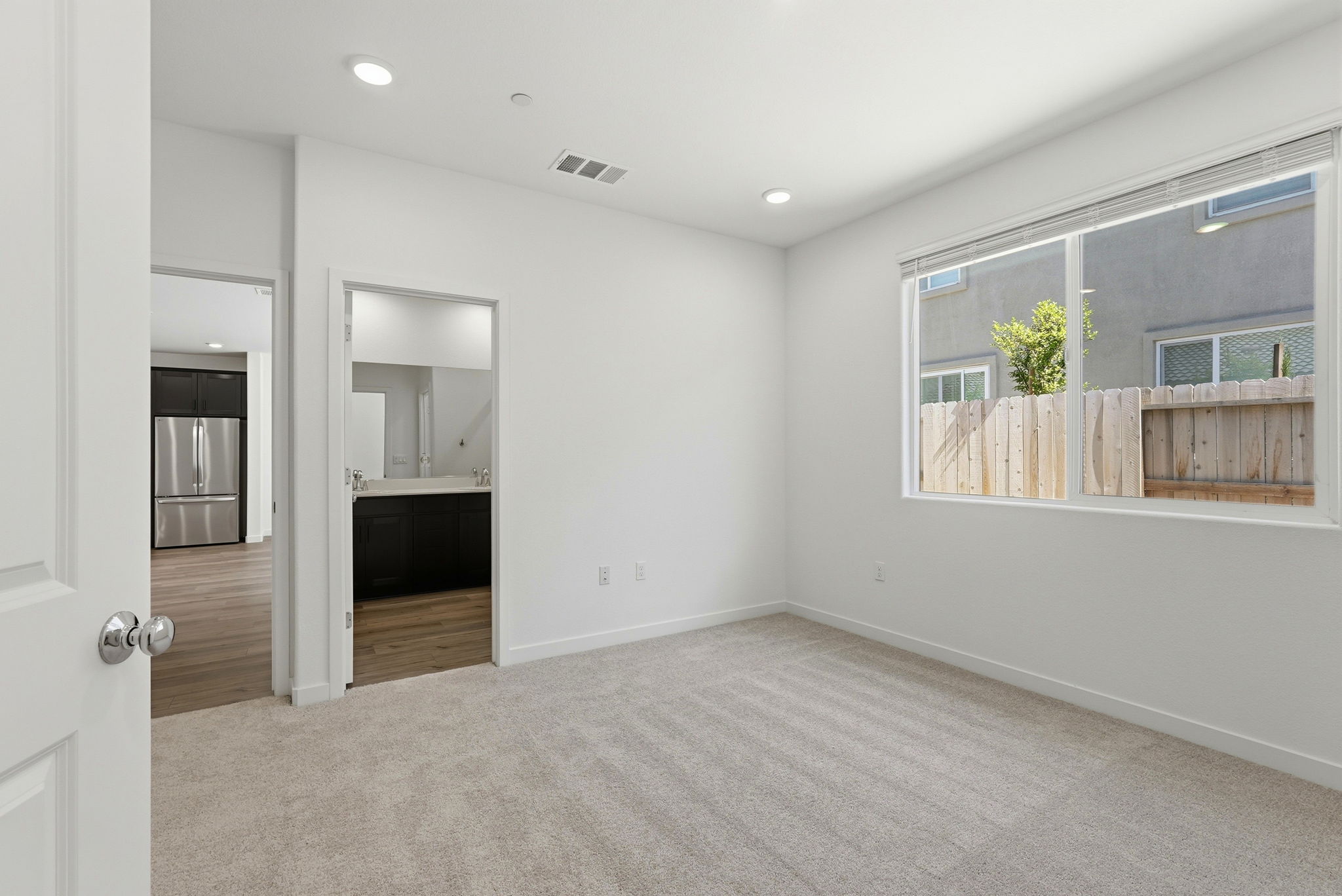 A room with a white wall and a window.