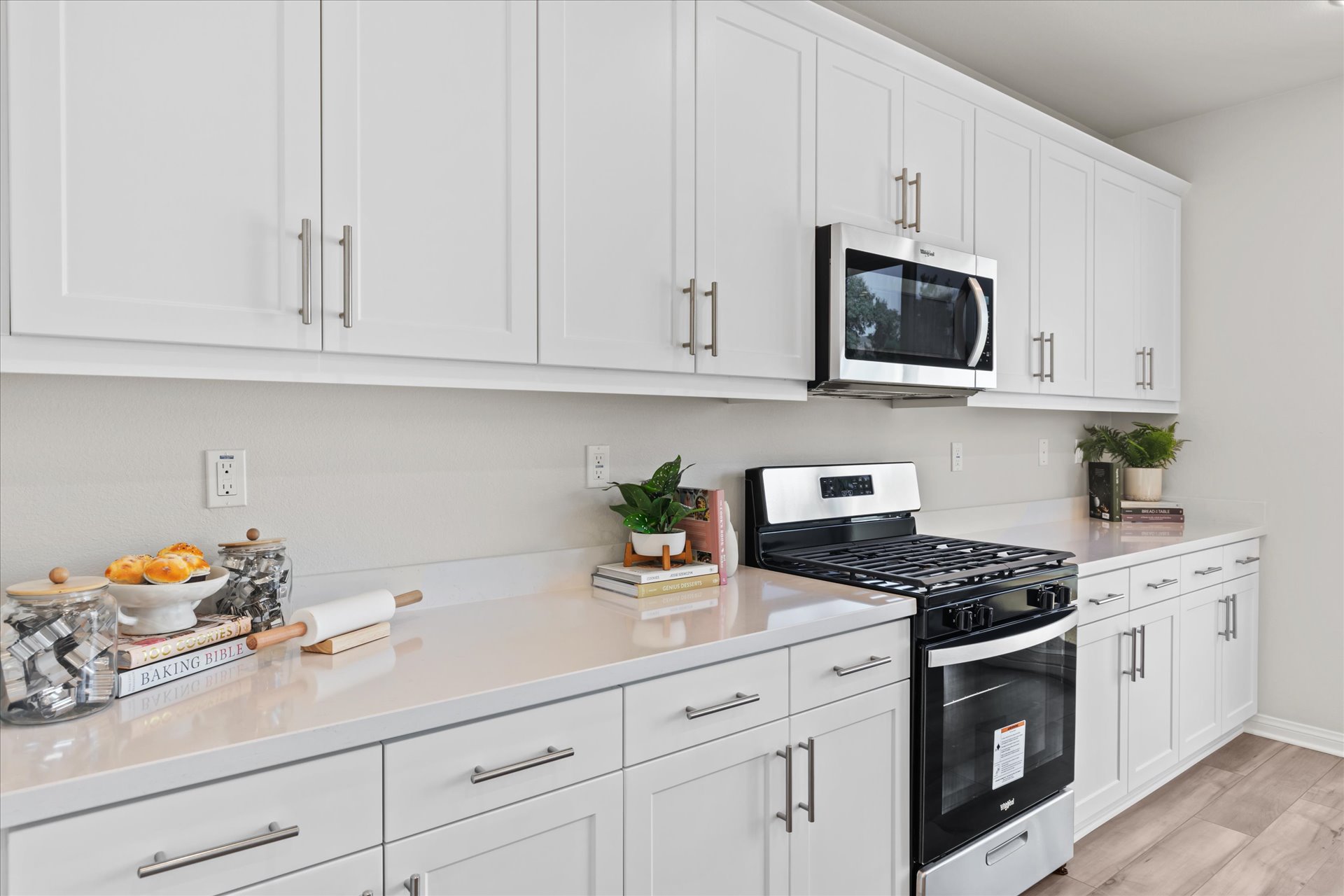 A kitchen with white cabinets.