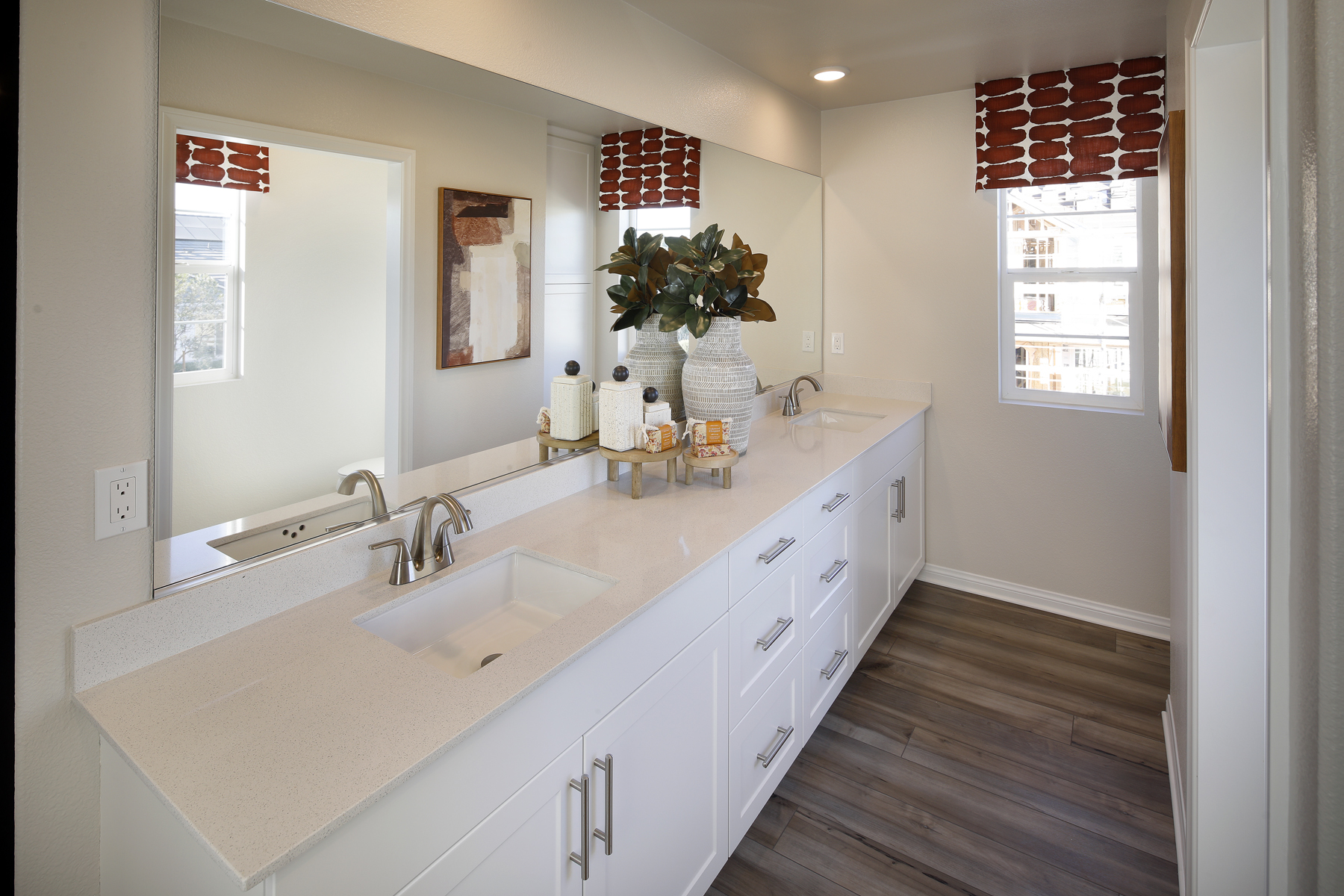 A bathroom with a large mirror.