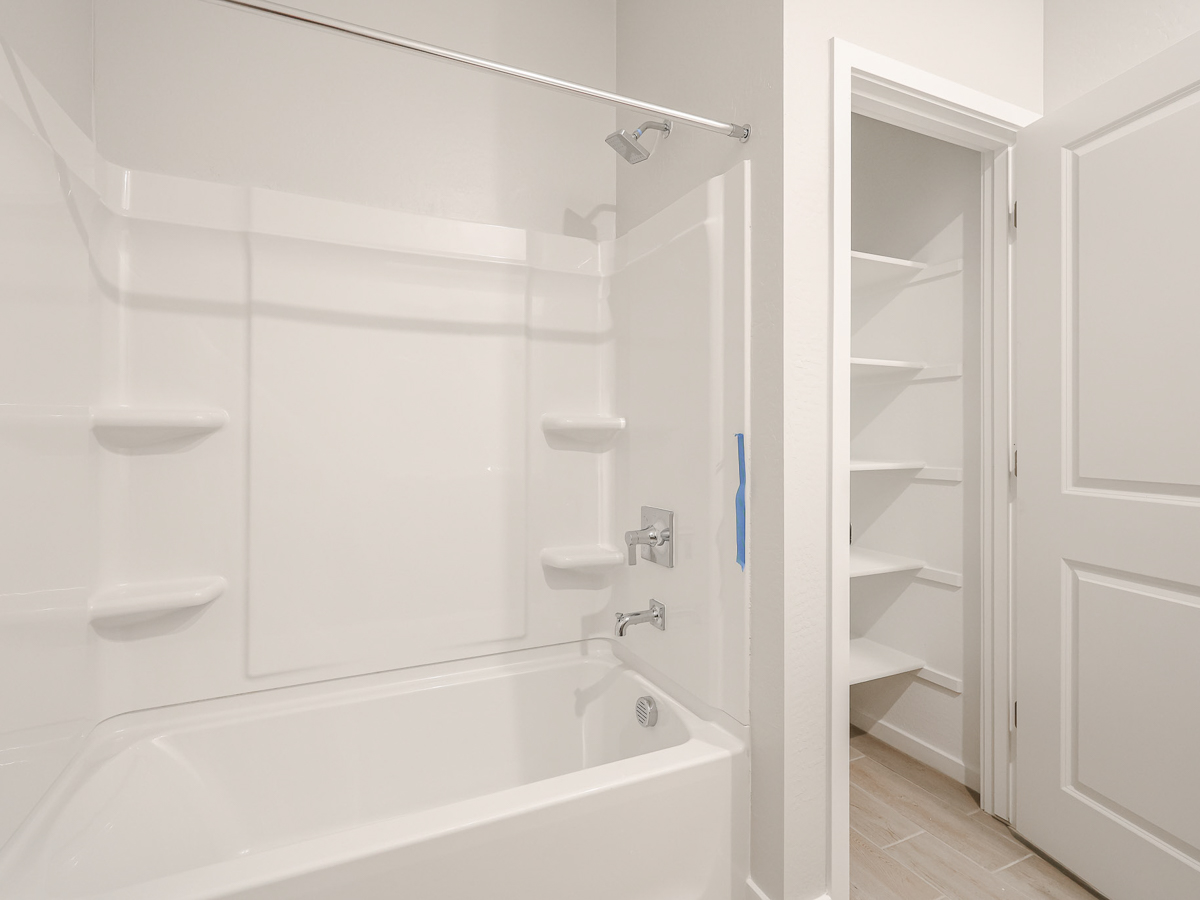 A bathroom with a white shower.