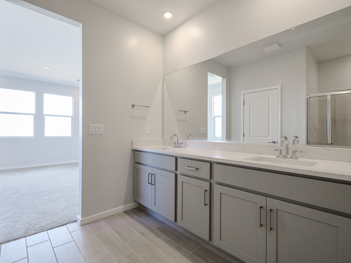 A bathroom with white cabinets.