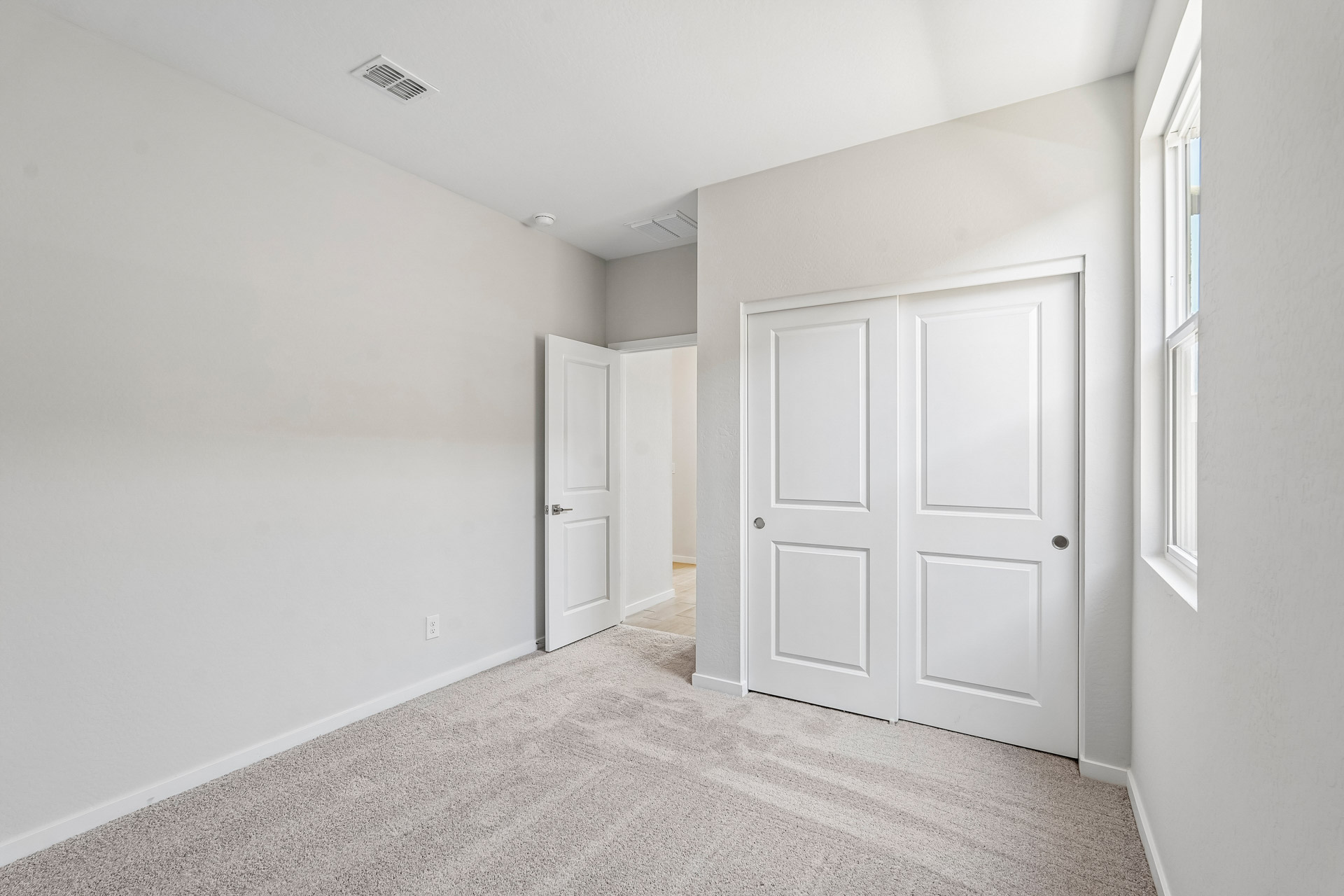 A hallway with white doors.
