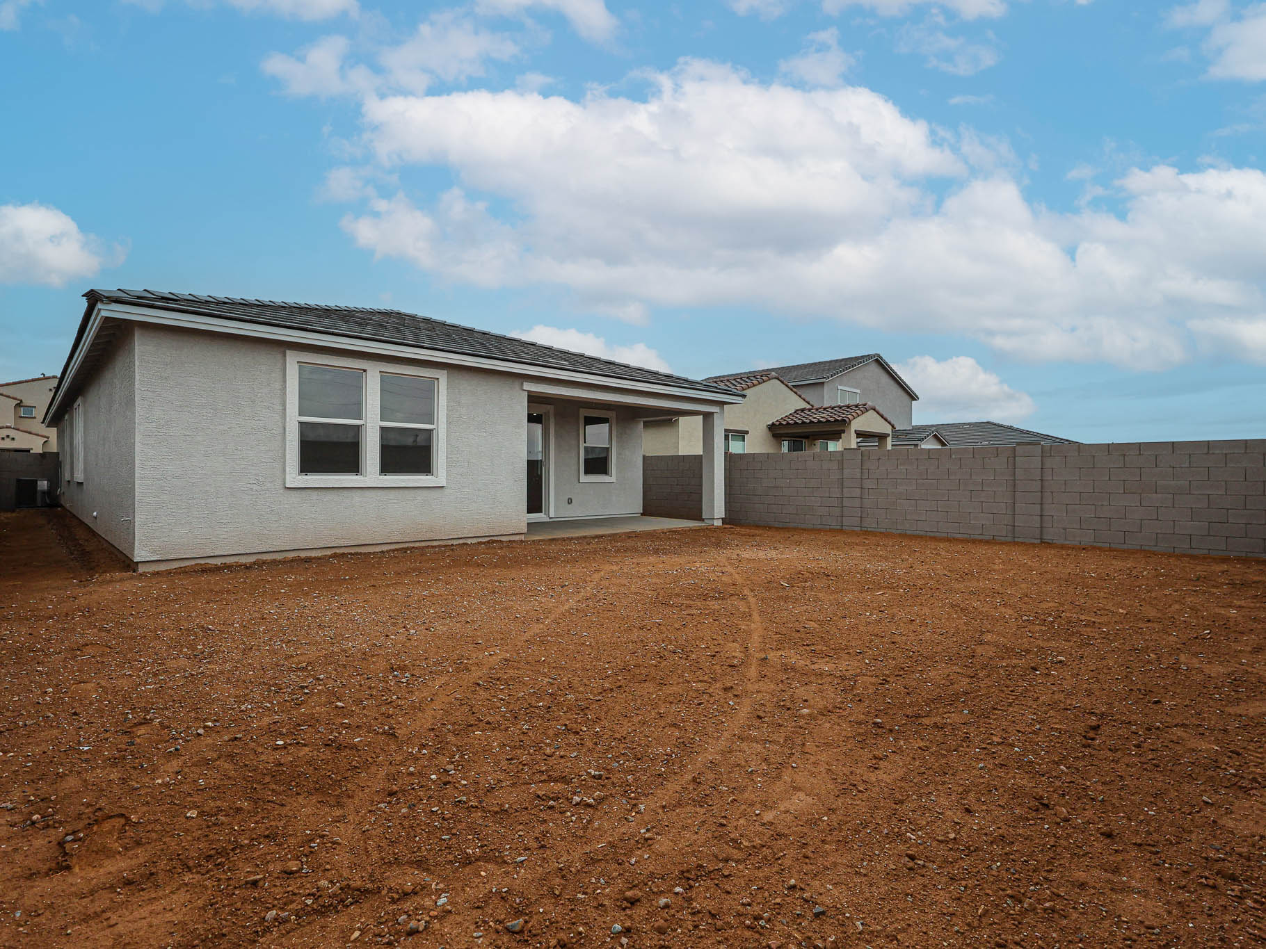 A house with a dirt yard.