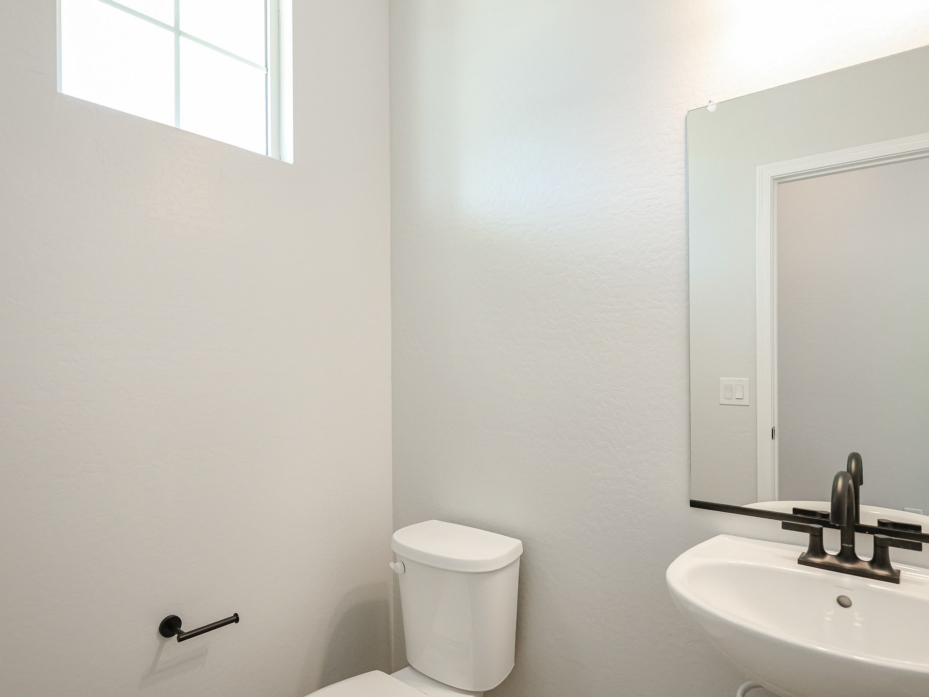 A bathroom with a toilet and sink.