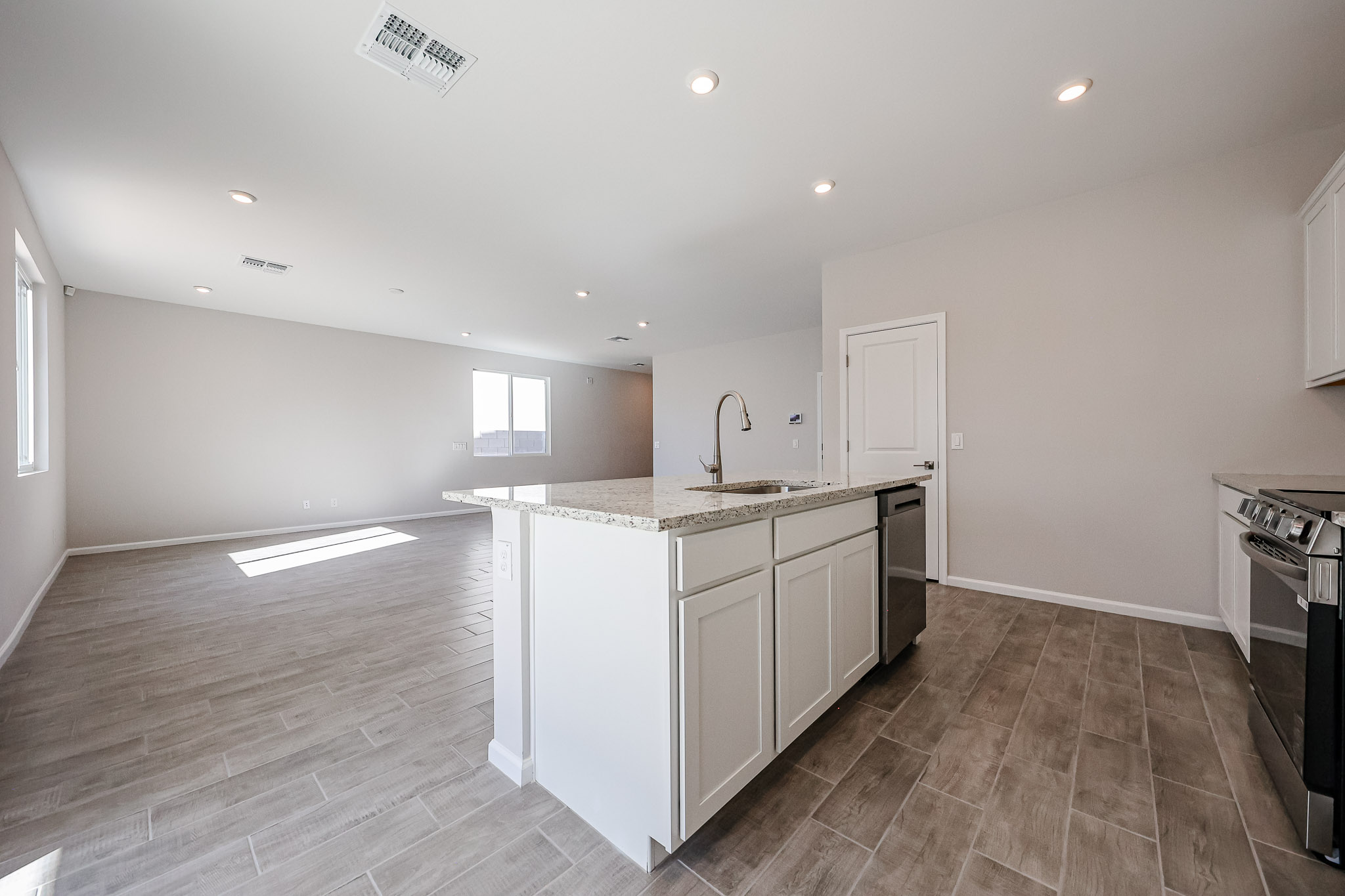 A kitchen with white cabinets.