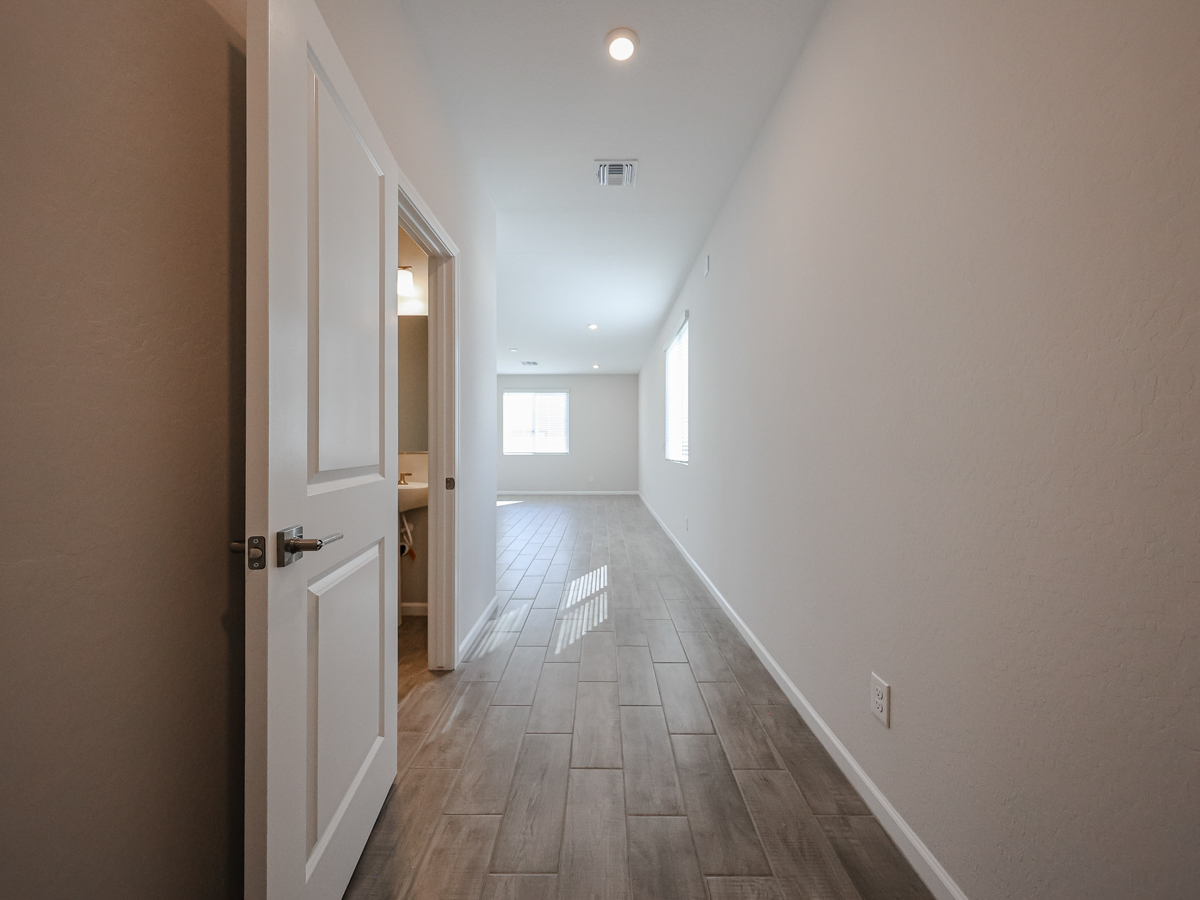 A hallway with white walls.