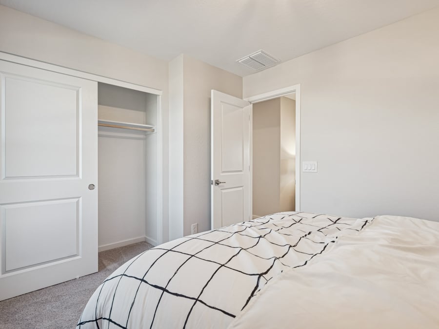 A bedroom with white walls.
