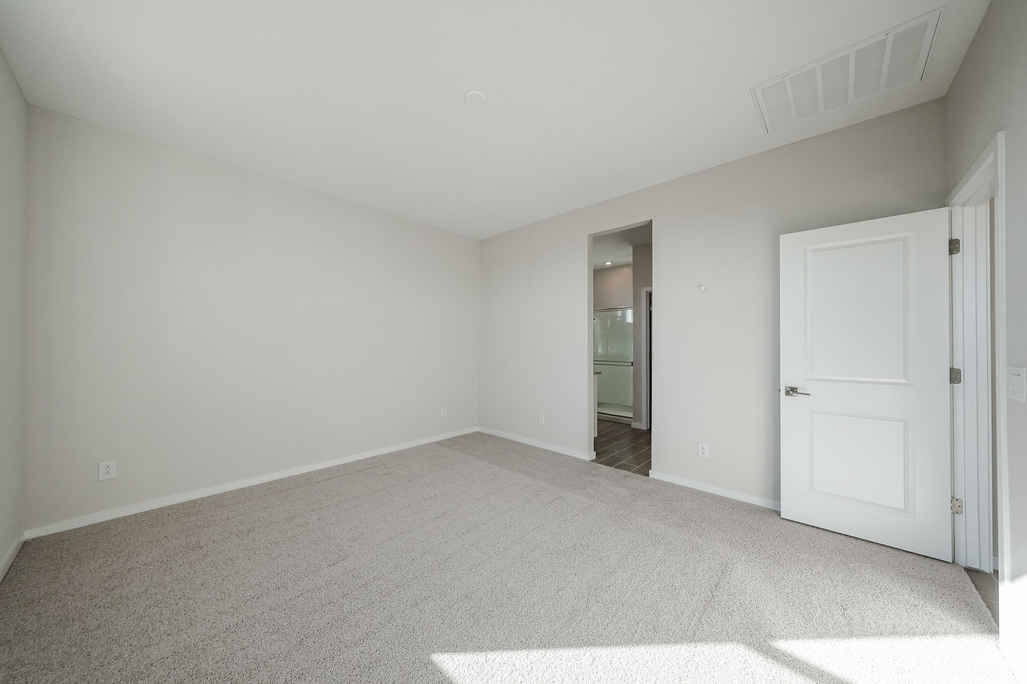 A hallway with white doors.