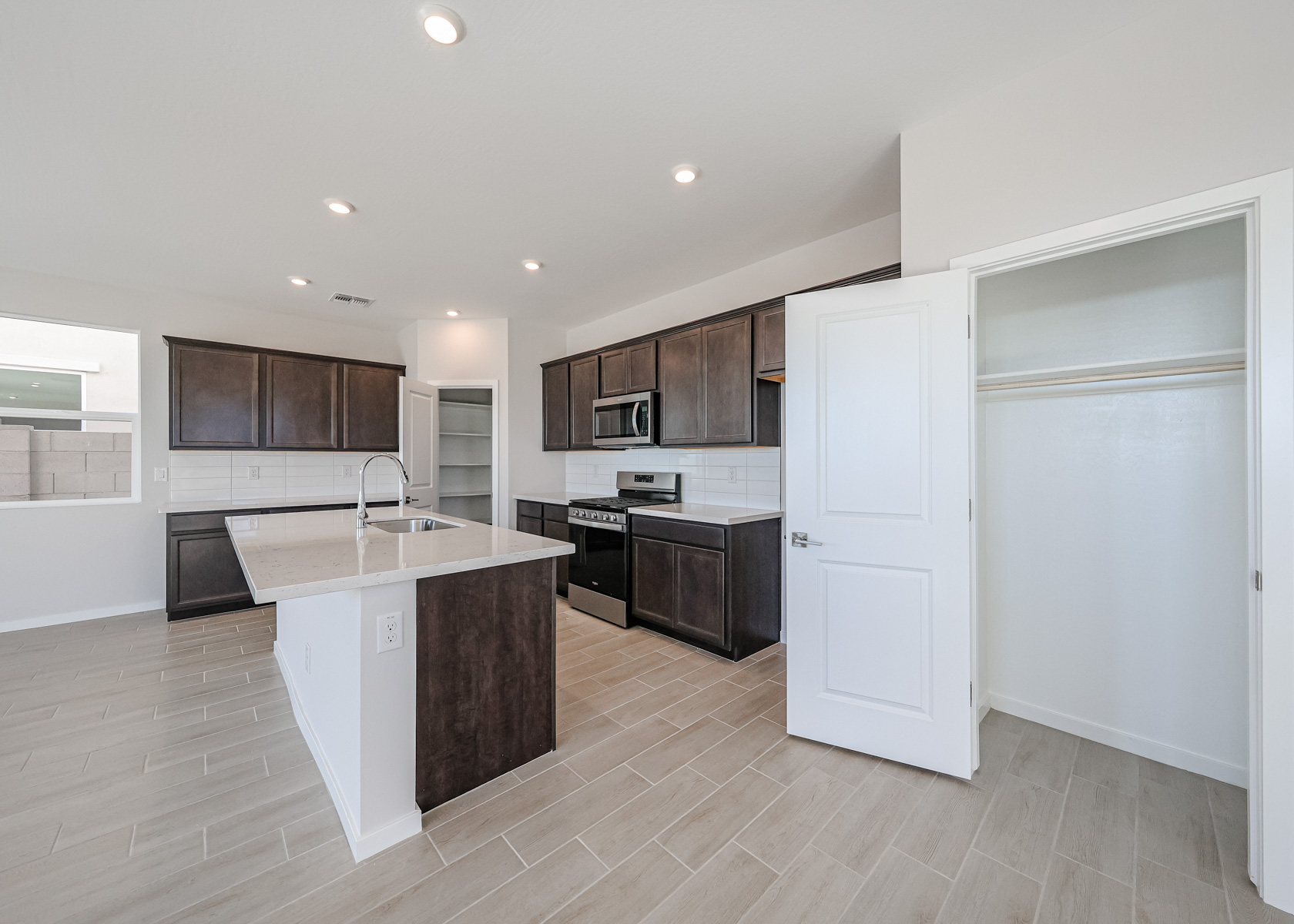 A kitchen with wooden cabinets.