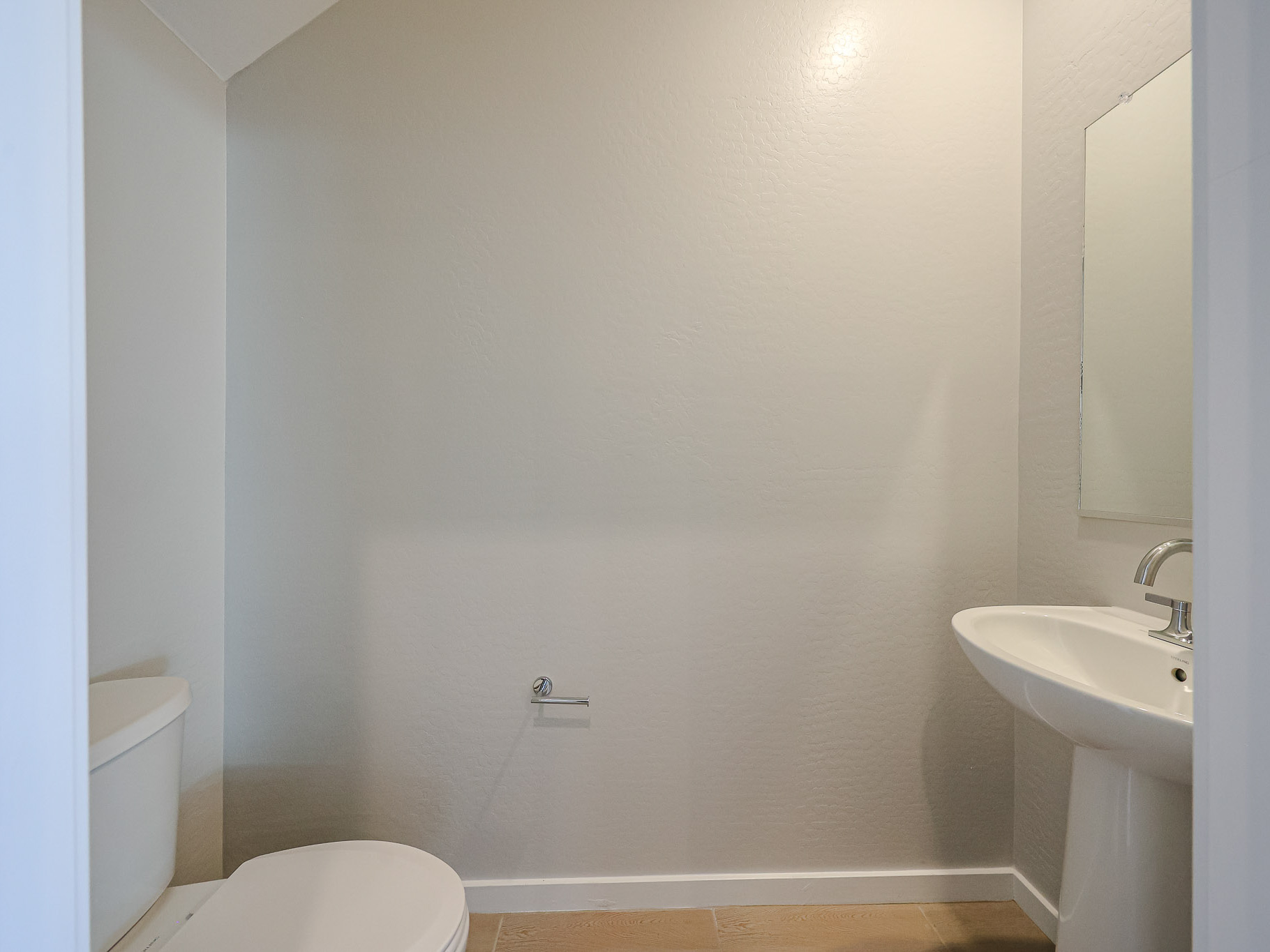 A bathroom with a sink and toilet.