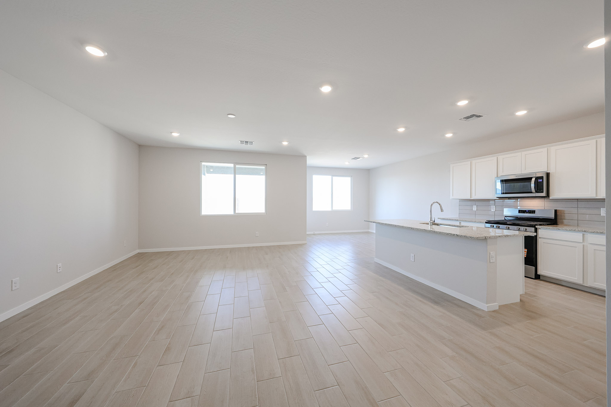 A large kitchen with white cabinets.