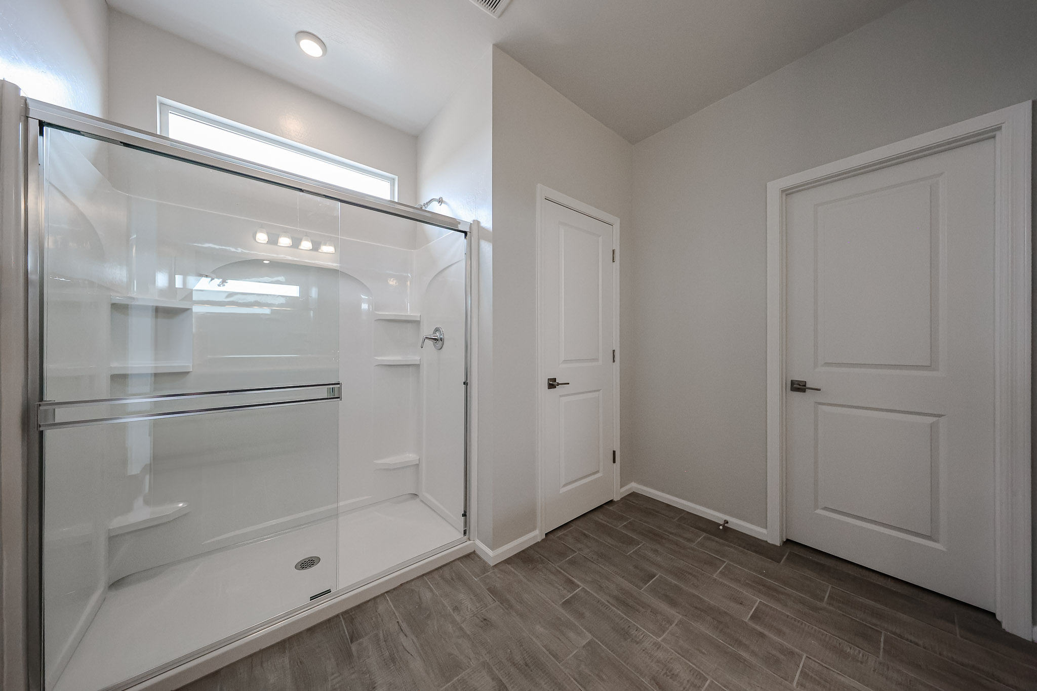 A bathroom with white cabinets.