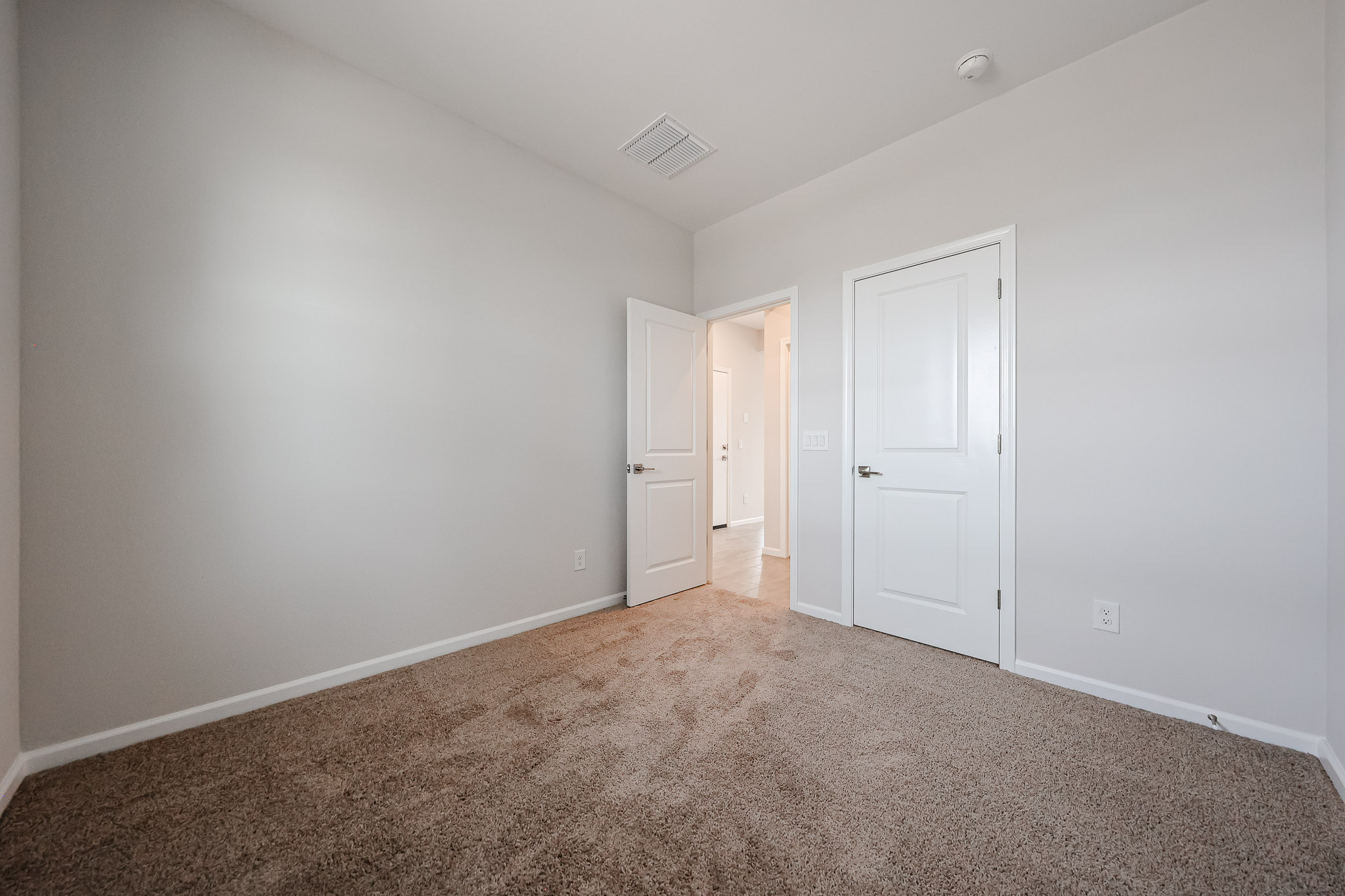 A hallway with white doors.