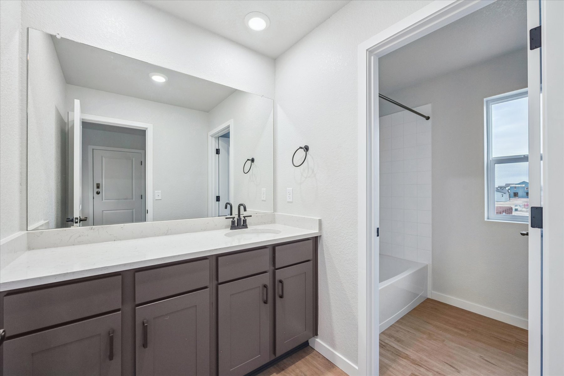 A bathroom with a tub sink and shower.