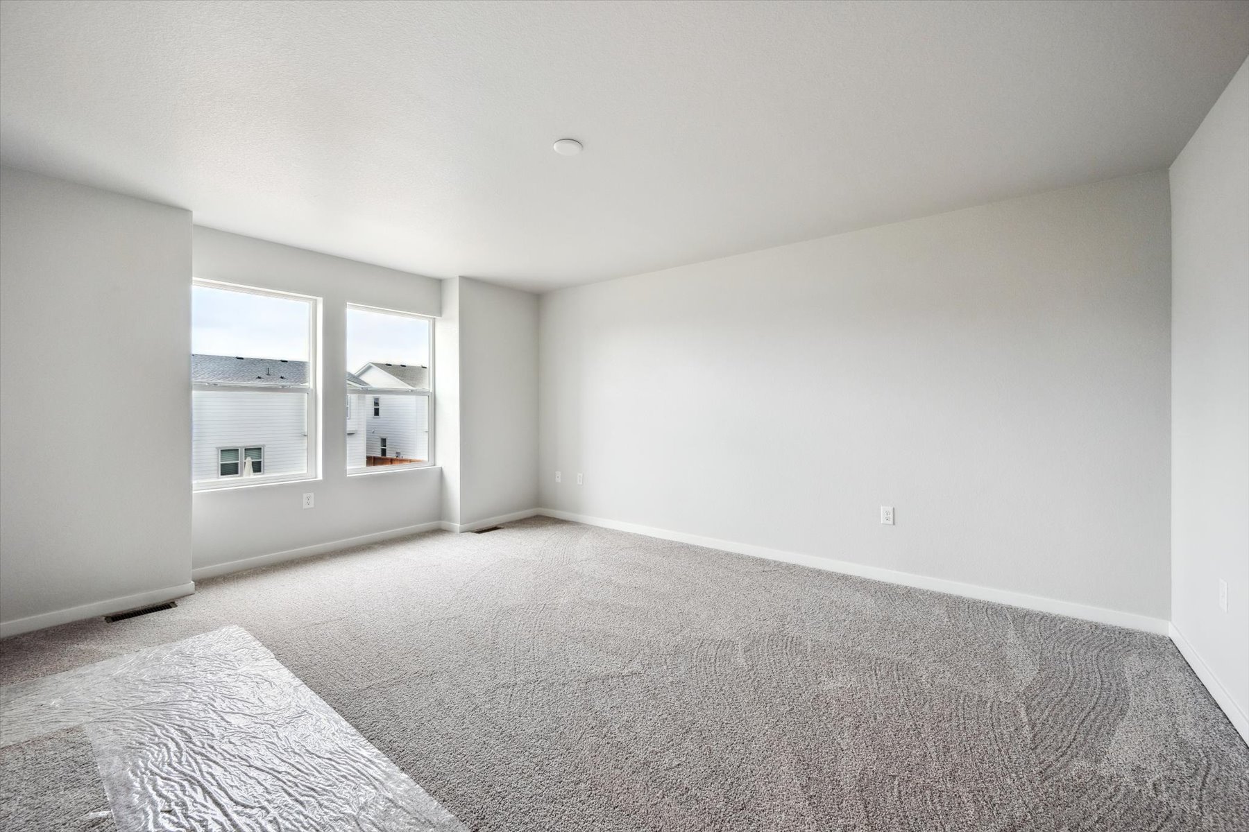 A room with a carpet and a rug.