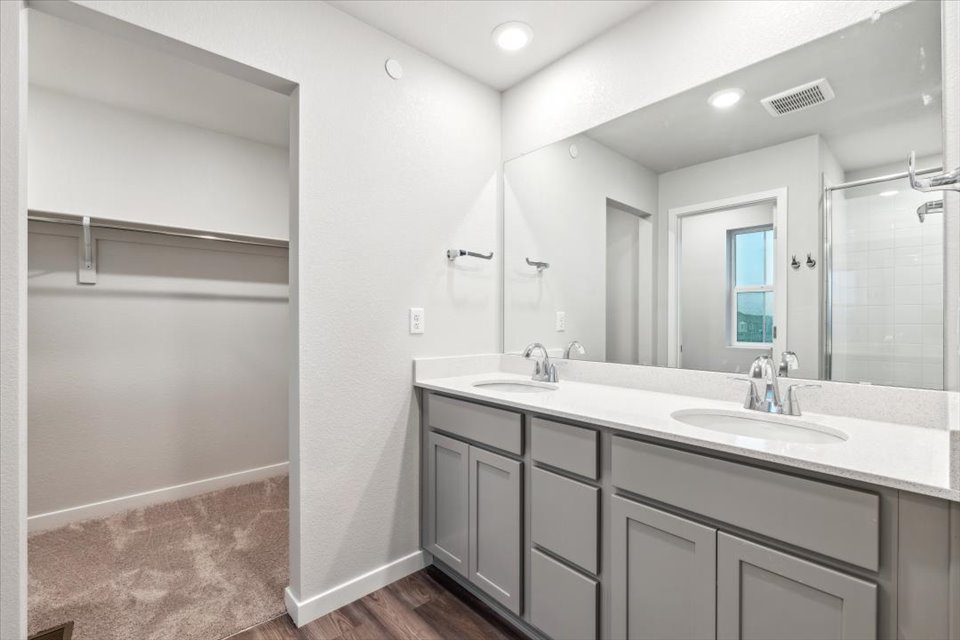 A bathroom with a large mirror.