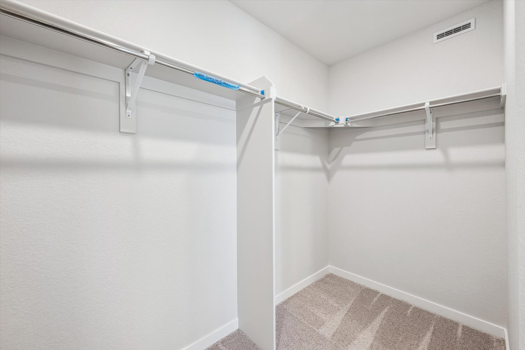 A white staircase with a metal railing.
