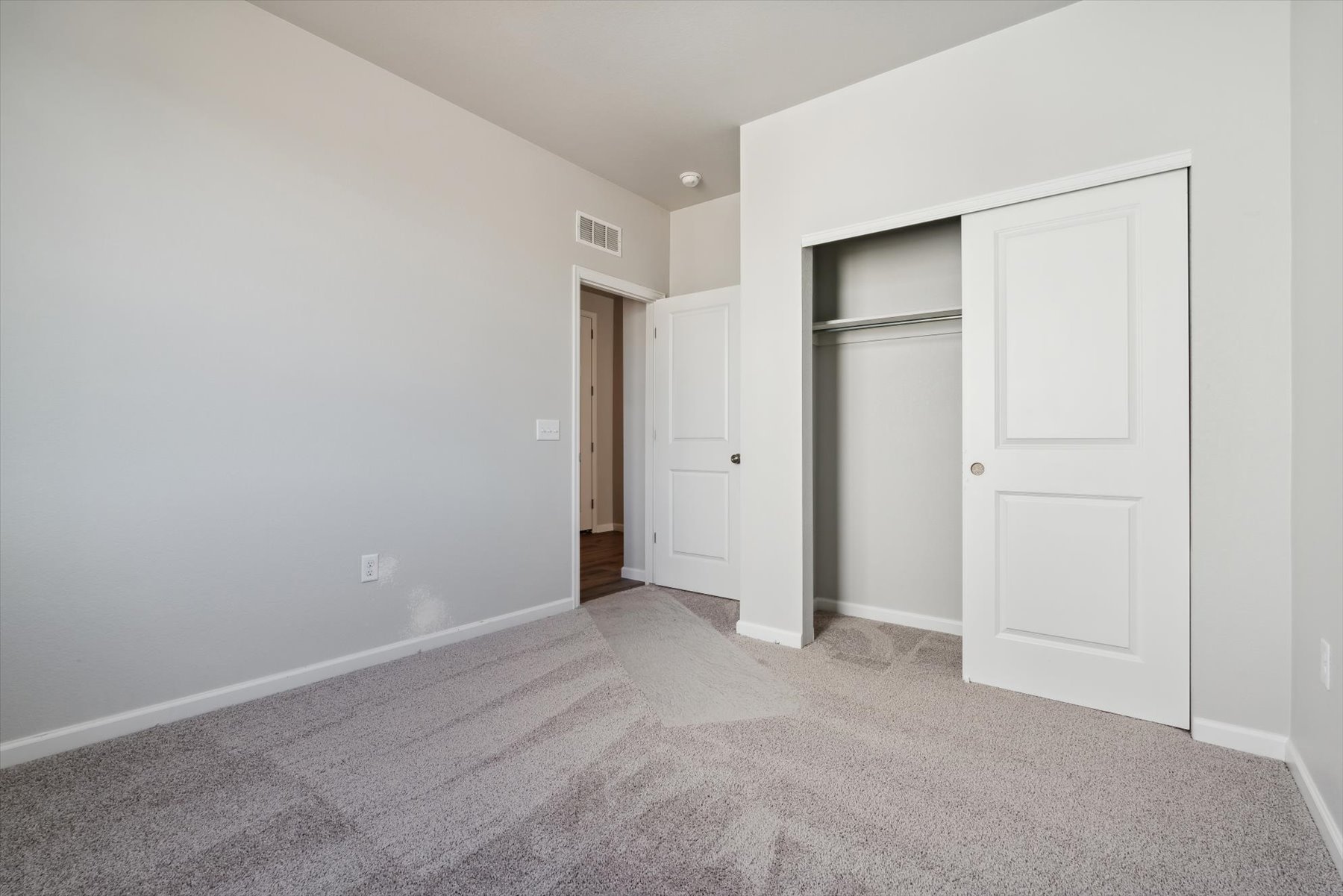 A hallway with white doors.