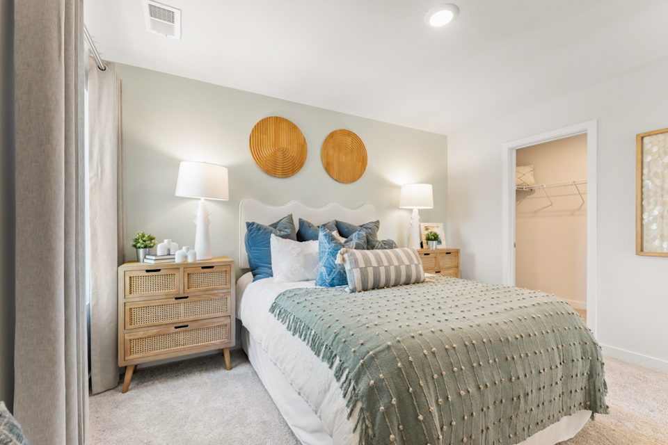 A bedroom with a bed and lamps.