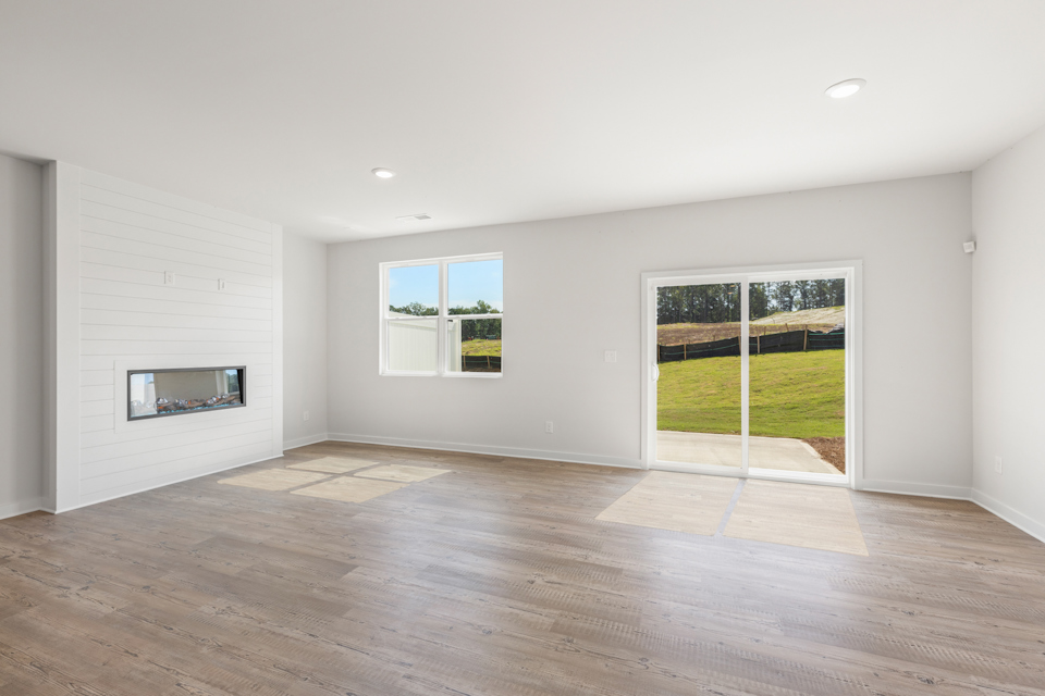 A room with a wood floor and a glass door with a window.