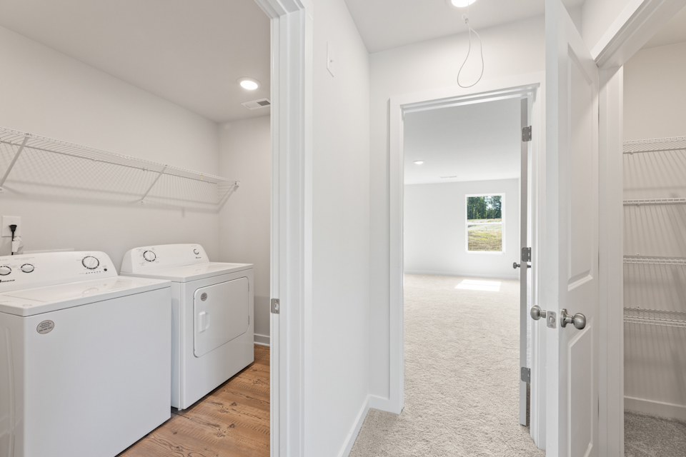 A bathroom with white cabinets.