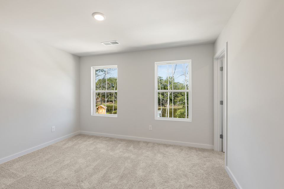 A room with windows and carpet.