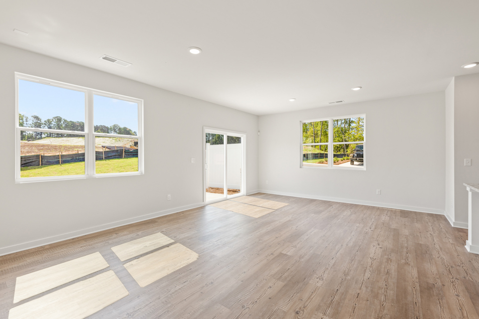 A room with a wood floor and windows.