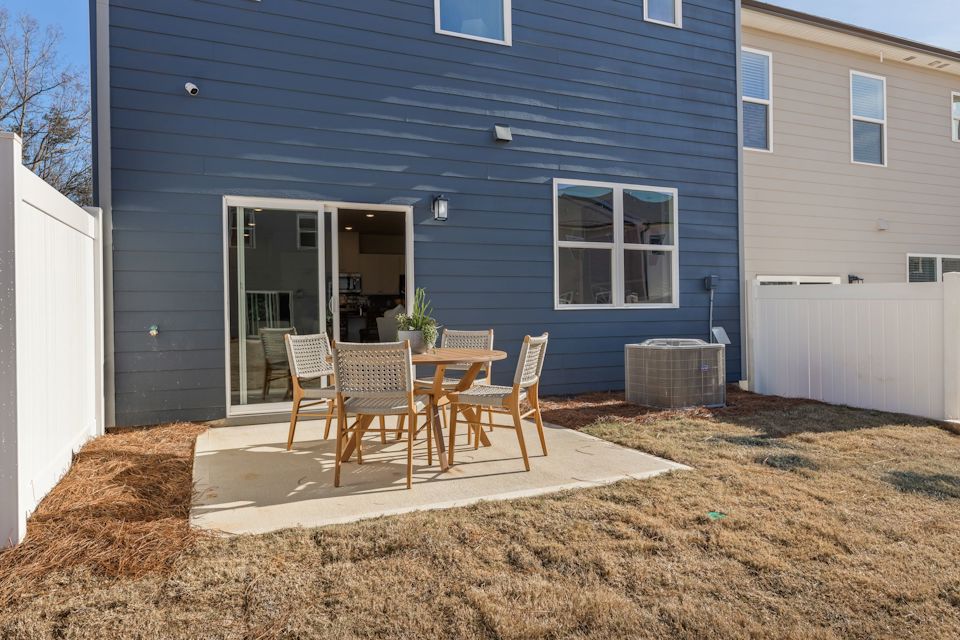 A table and chairs outside a house.