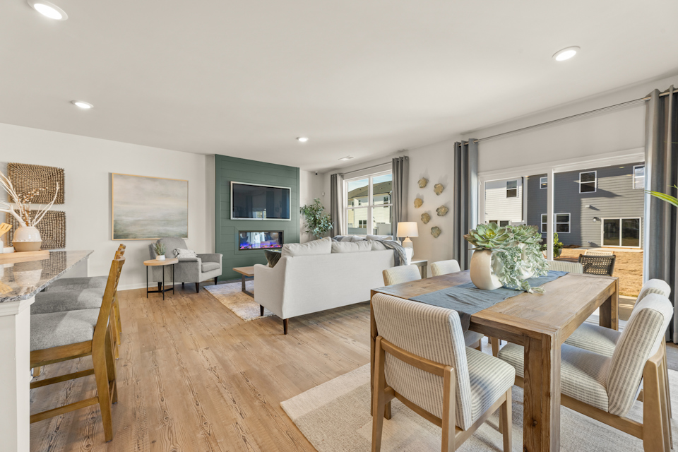 A large living room with a large dining table and chairs.