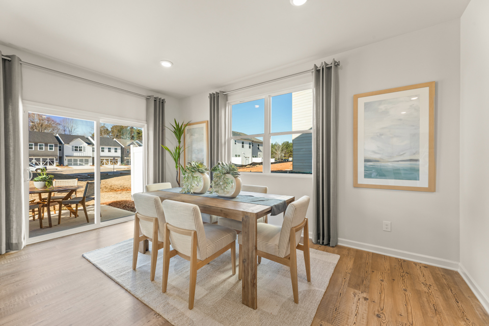 A dining room with a large window.
