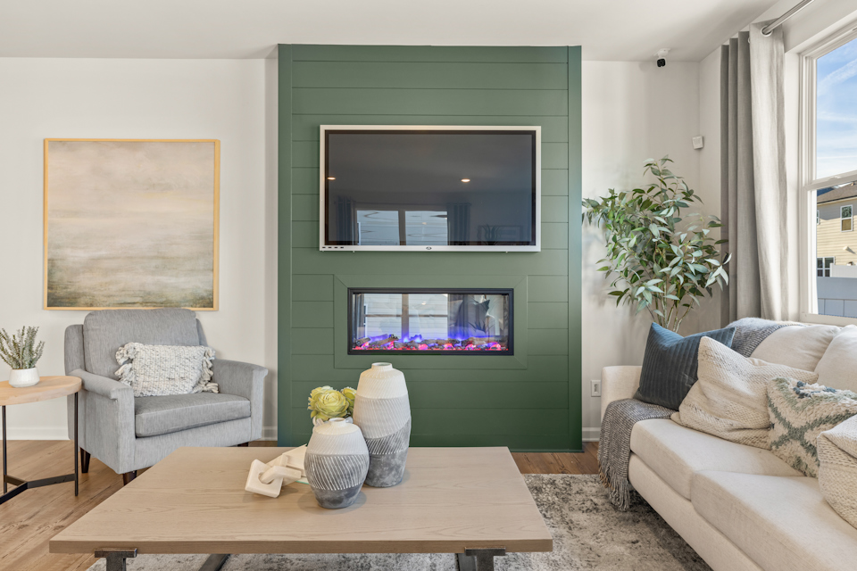 A living room with a green wall.