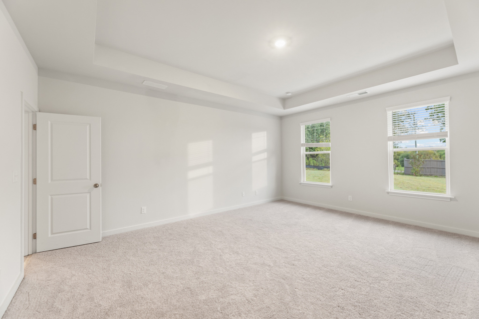 A room with white walls and windows.