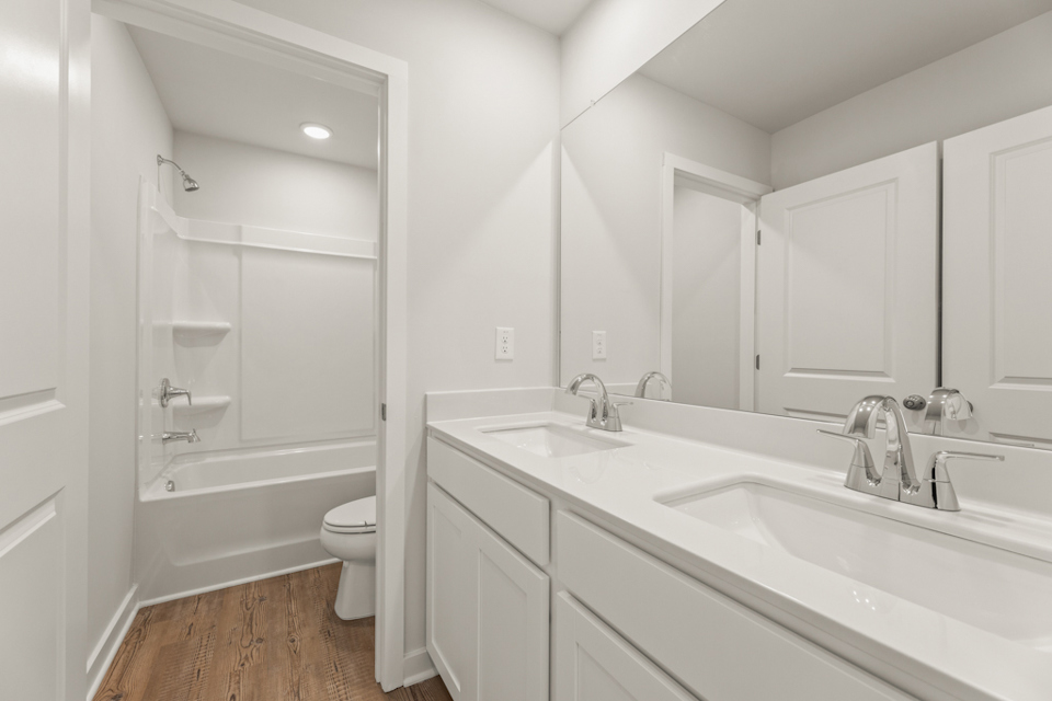 A bathroom with a tub sink and toilet.