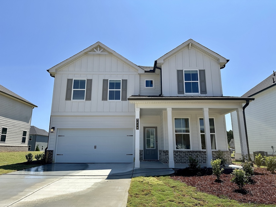 A white house with a driveway.