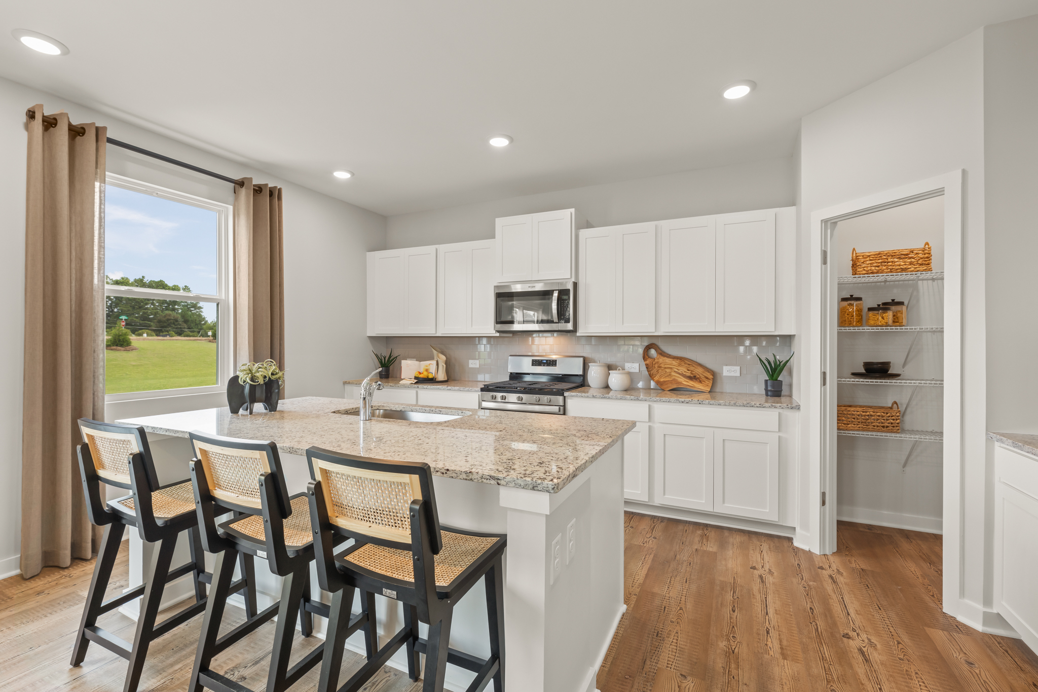 A kitchen with white cabinets.