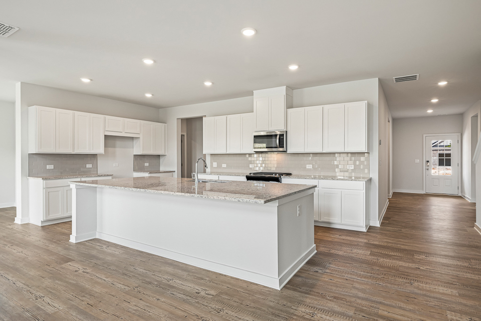 A kitchen with white cabinets.