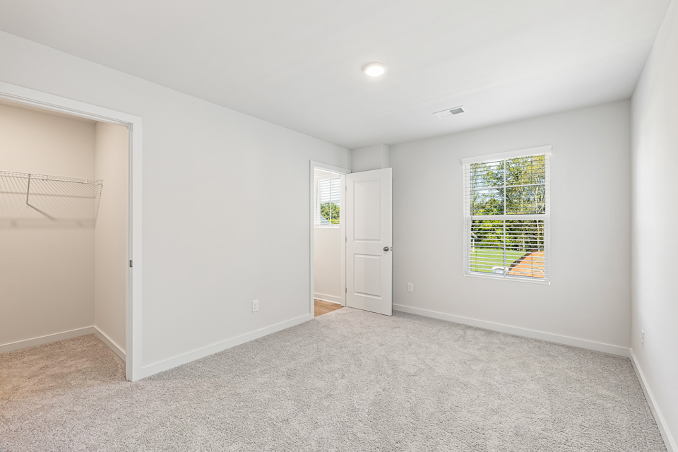 A room with white walls and a window.