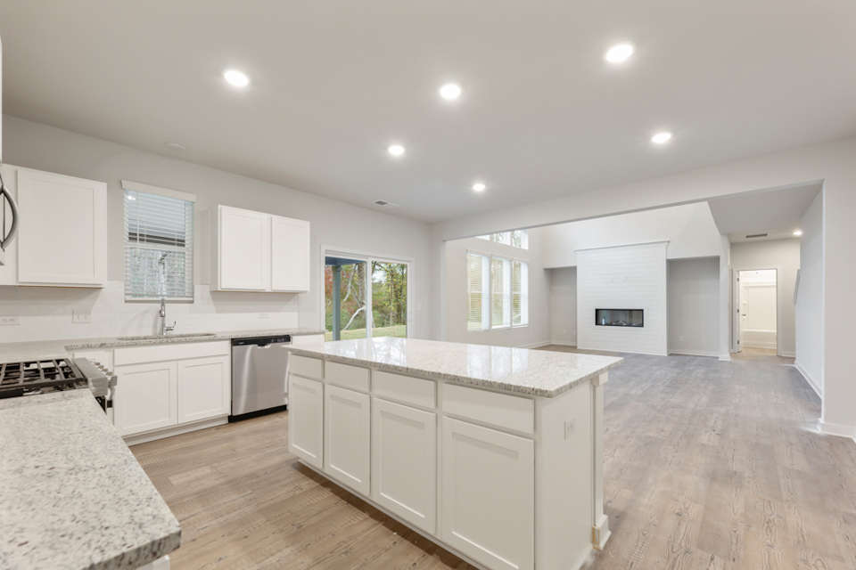 A kitchen with white cabinets.